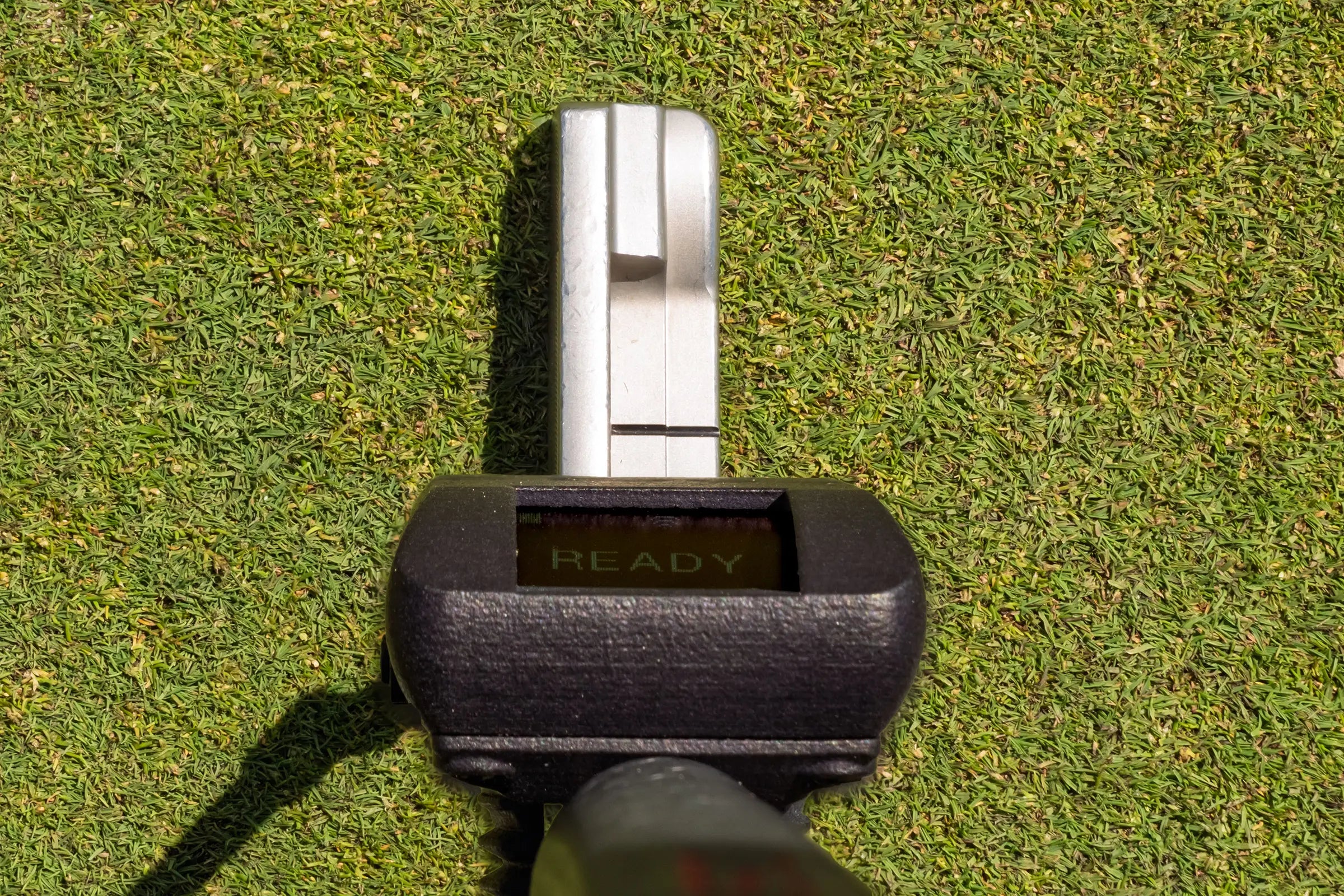Capto Golf putting sensor attached to a putter, showing ready status for stroke analysis and putting performance tracking on the green.