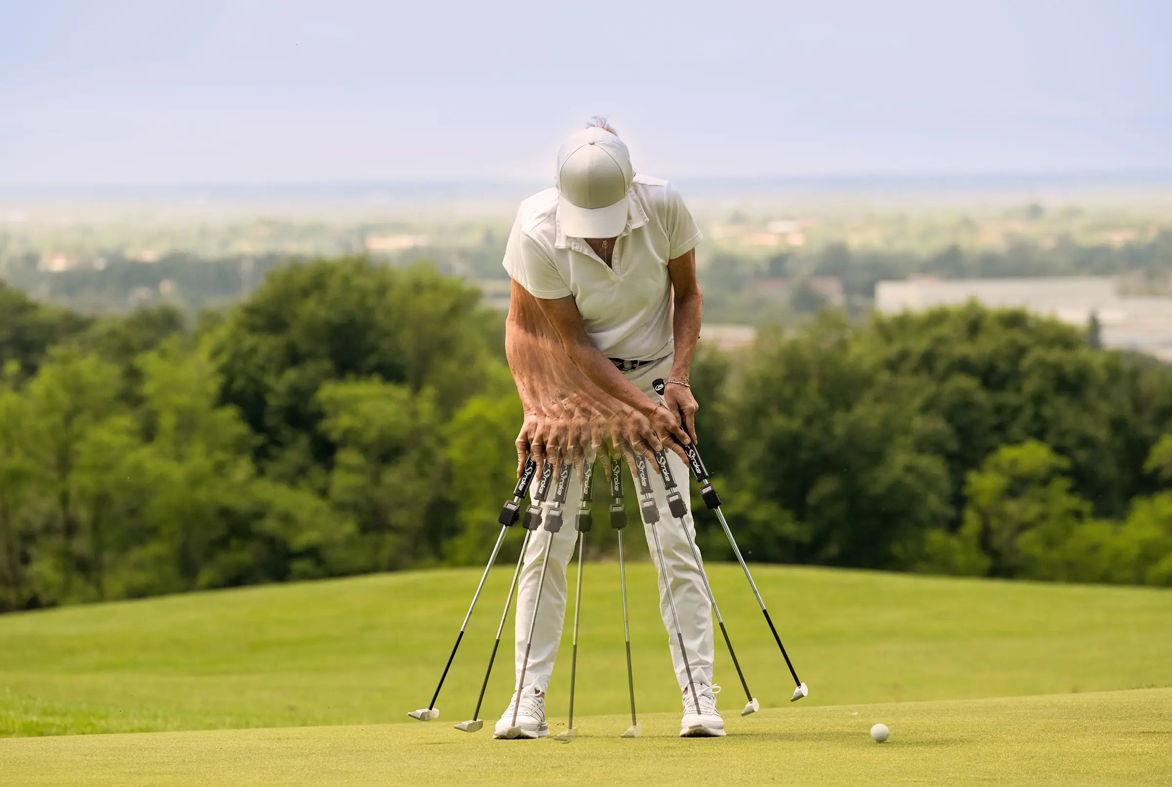 Golfer using Capto putting analysis sensors to track stroke movement and club position during a putt on the green.